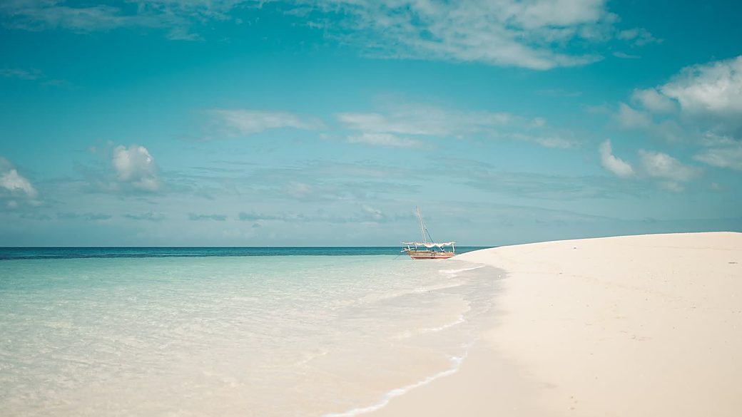 Dhow on a turquoise Safari Blue sandbank