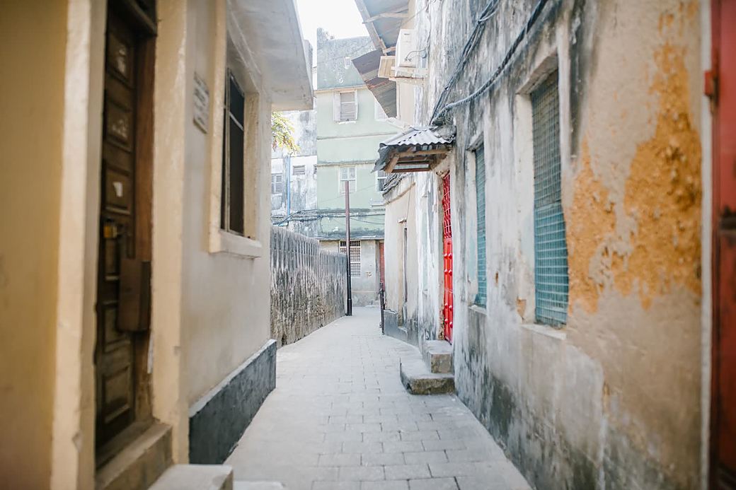A narrow Stone Town alley with carved doors